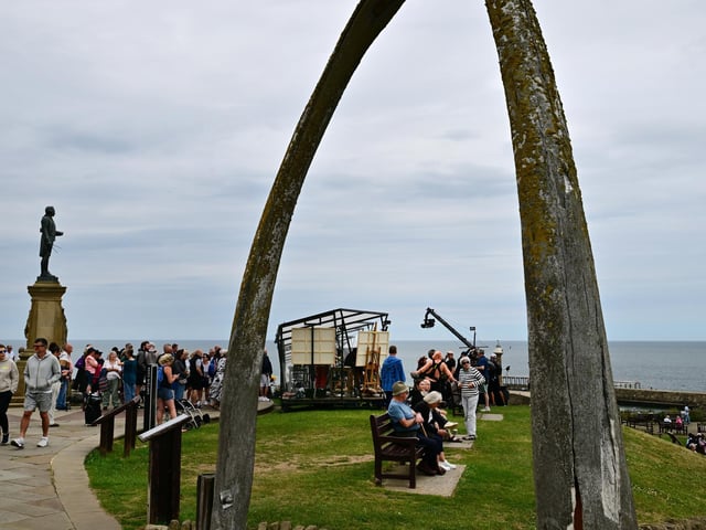 The iconic Whale Bones frame the filming set.
