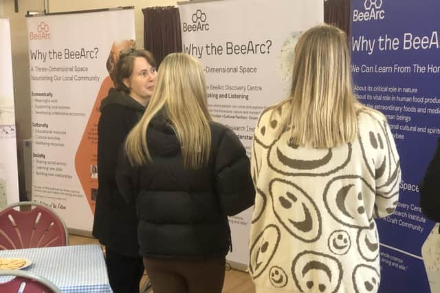 Lucy Kaya of the BeeArc Trust showing visitors round the exhibition.
