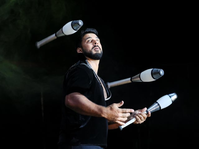 A talented juggler puts on a show.