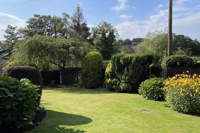 Lawned and enclosed gardens contain a colourful variety of trees, plants and shrubs.