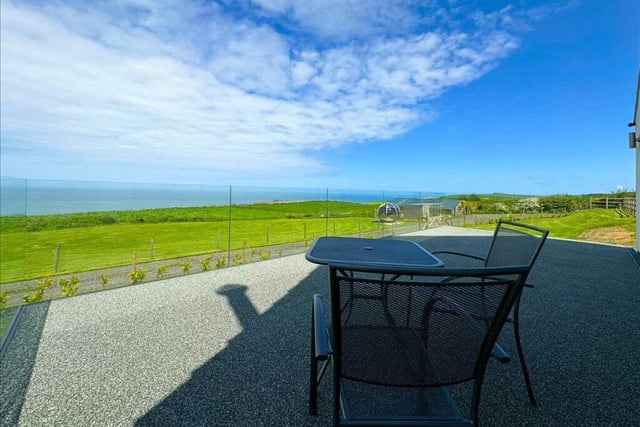 The extensive sun terrace outside the property has glorious views.