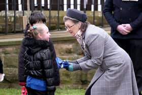 Venetia Wrigley hands over the Commonwealth flag to Gldastone Road School pupils. picture: Richard Ponter