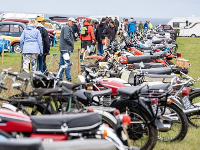 Visitors view the vintage motorcycles