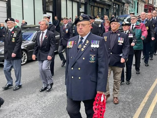 A parade marches to Scarborough Lifeboat Station, watched by large crowds.