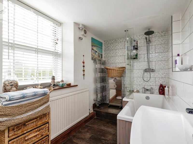 A sizeable bathroom has both bath and shower.