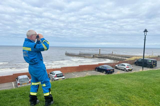 Coastguard Rob Parkin searches from the West Cliff - Image: RNLI/Ceri Oakes