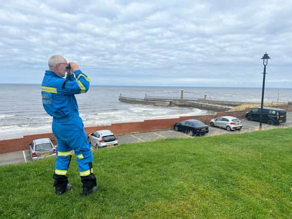 Coastguard Rob Parkin searches from the West Cliff - Image: RNLI/Ceri Oakes