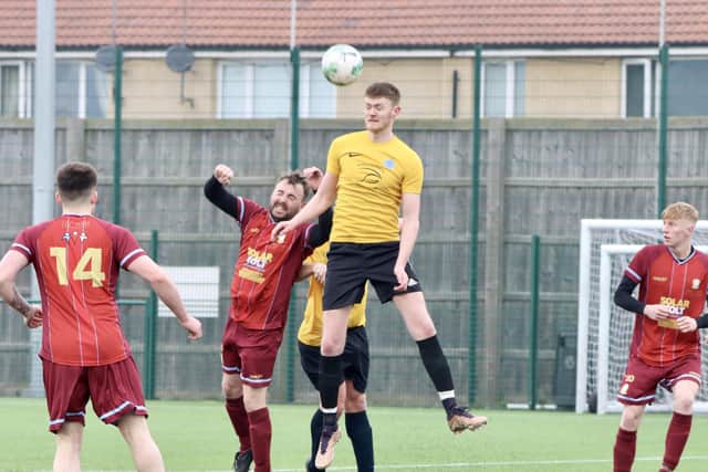Flamborough, yellow shirts, win a header in their derby defeat to Brid Rovers Reserves. PHOTOS BY TCF PHOTOGRAPHY