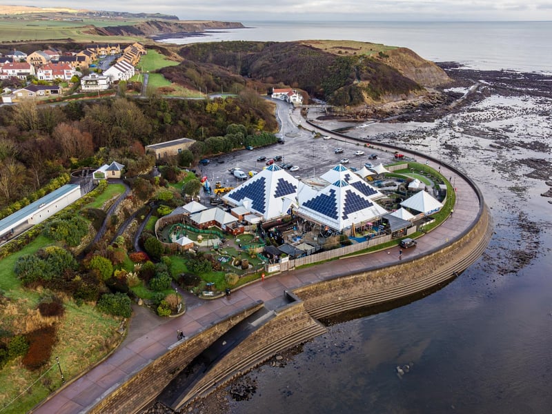 Solar engineers fix a row of solar panels, completing a complex installation on the iconic pyramid shaped roofs of SEA LIFE, Scarborough. Photo by Toby Smith / Good Energy
