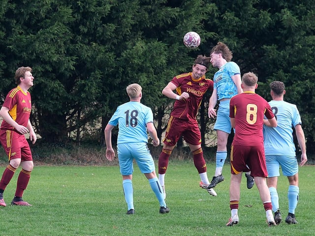 Players try to win this aerial duel. Photo by Richard Ponter