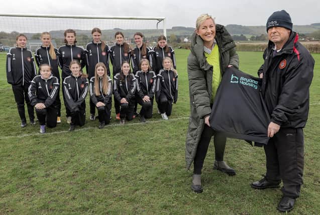Beyond Housing Community Connector Coordinator Stephanie Lake (front, left) presents the new Beyond Housing sponsored strip to the Scarborough Ladies U14 team, with their Manager Colin Hepples (front, right).