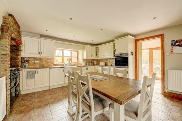 The large, cottage style dining kitchen has a Rayburn range cooker.