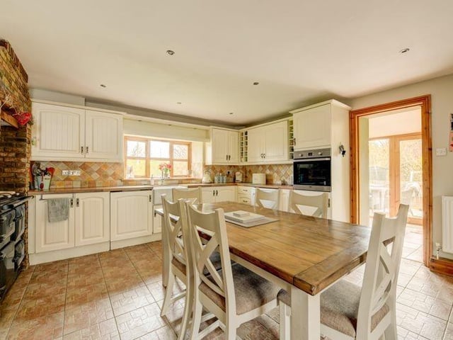 The large, cottage style dining kitchen has a Rayburn range cooker.