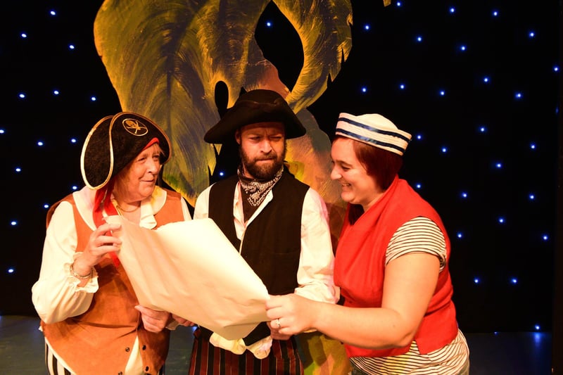 Sea Snake Sally (Sally Fewster), Long John Silver (Ivan Hall) and Blind Ali (Kirsty Dixon) survey the map in search of treasure.