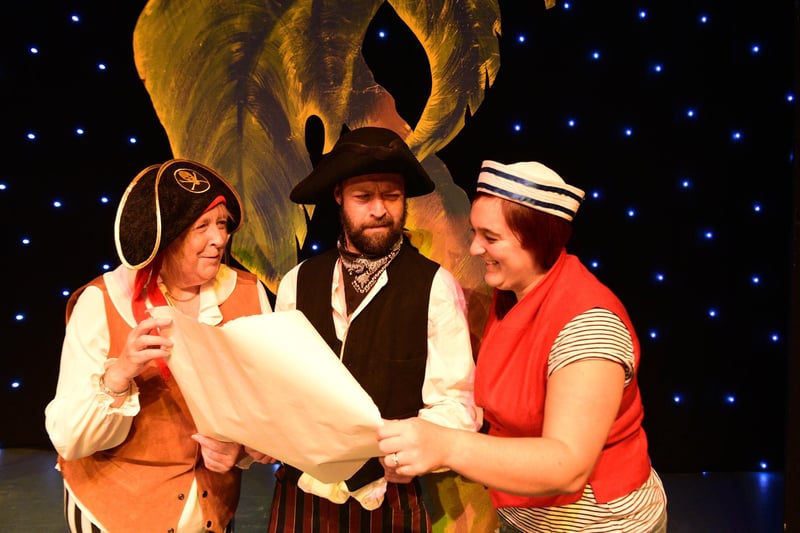 Sea Snake Sally (Sally Fewster), Long John Silver (Ivan Hall) and Blind Ali (Kirsty Dixon) survey the map in search of treasure.