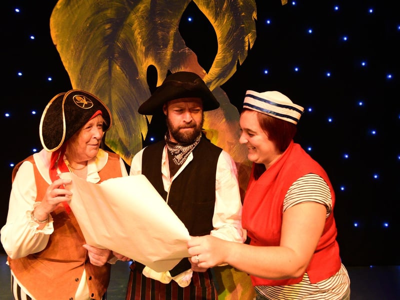 Sea Snake Sally (Sally Fewster), Long John Silver (Ivan Hall) and Blind Ali (Kirsty Dixon) survey the map in search of treasure.