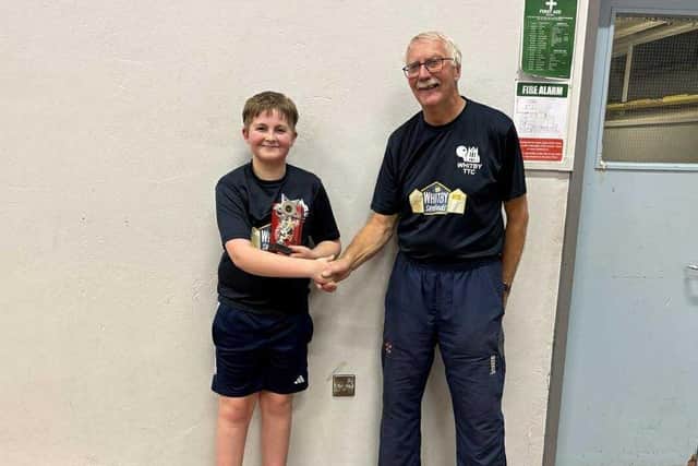 Youngster Charlie Sedman won the Whitby Table Tennis Club Christmas Handicap tournament. He is pictured receiving the trophy from club chairman, Mike Stones
