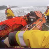 Whitby's inshore lifeboat crew members rescue three swimmers from a rip current at Sandsend.