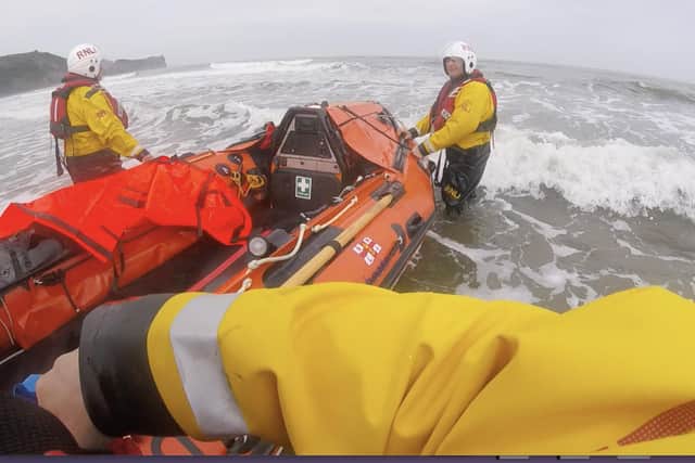 Whitby's inshore lifeboat crew members rescue three swimmers from a rip current at Sandsend.