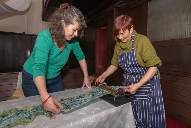 Sarah Priestley, left, and Viv Mousdell work on an arts project as part of The Living on the Edge of the World festival in Whitby.
