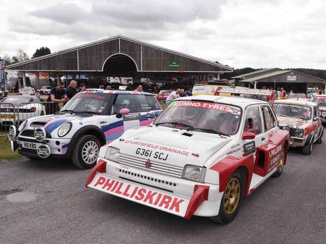 Rally cars wait on the start line.