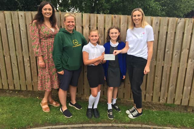 Camarah Mosey, Headteacher, Helen Wilford, Chair of Thornton Dale Primary PTA, students from Thornton Dale Primary School, and Lorna Mann, Pavers