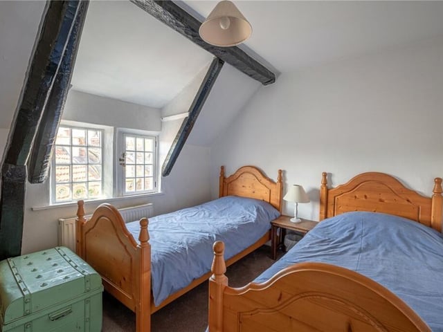 A character bedroom with wooden beams.