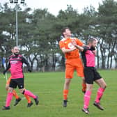 Heslerton's Tommy Palmer wins a header against Slingsby. PHOTO BY CHERIE ALLARDICE