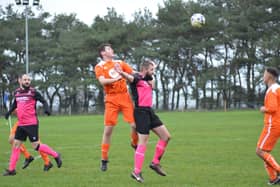 Heslerton's Tommy Palmer wins a header against Slingsby. PHOTO BY CHERIE ALLARDICE