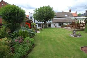 Mature and private gardens with seating areas and a summerhouse stretch to the rear of the property.