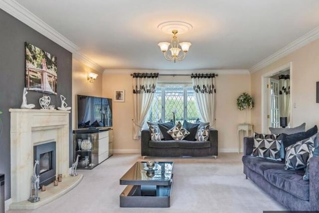 A spacious lounge has a feature fireplace and large bay window.
