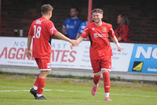 Billy Ripley congratulates Matty Bowman after his first goal for the club.