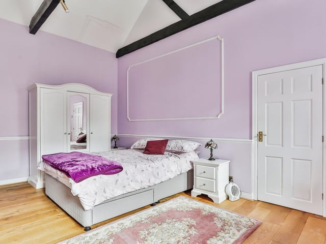 A beamed double bedroom within the cottage.