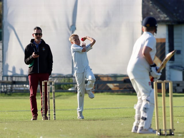 A Brid U13s bowler races in.