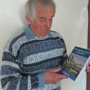 Former Eskdale School Head Dave Bradley with a copy of his first novel, William Bradley's Handcart.