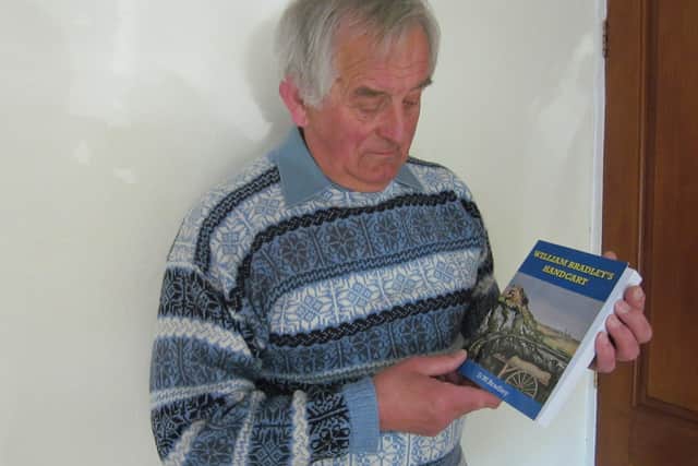 Former Eskdale School Head Dave Bradley with a copy of his first novel, William Bradley's Handcart.