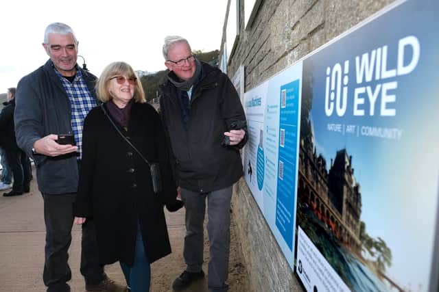 Scientist Magnus Johnson, Jane Pottas and Stuart Barnes examine the information boards