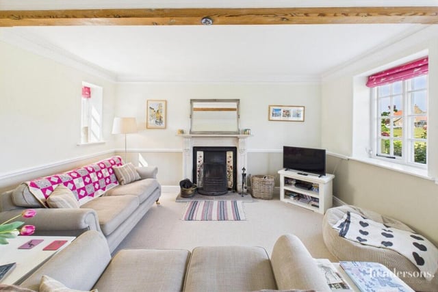 A light and spacious lounge with an open fire.