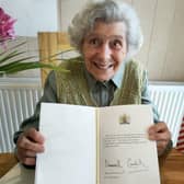 Joan Paylor with her 100th birthday card from King Charles III.