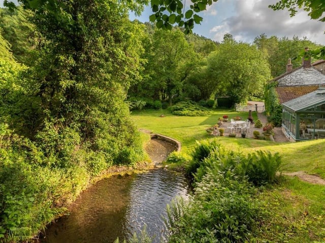 An idyllic garden and surroundings include two trout filled streams and a 12 ft waterfall.