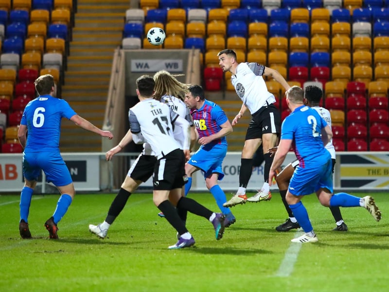 Defender Will Thornton heads the ball for Athletic.