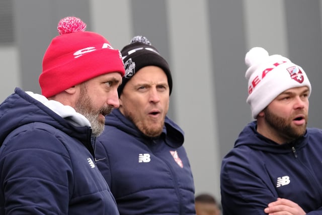 The Scarborough Athletic manager Jonathan Greening, left, and his coaches look on.