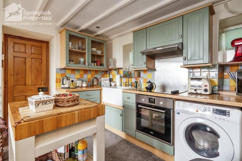 A country kitchen and diner has fitted units, and doors out to a decked balcony with lovely views.