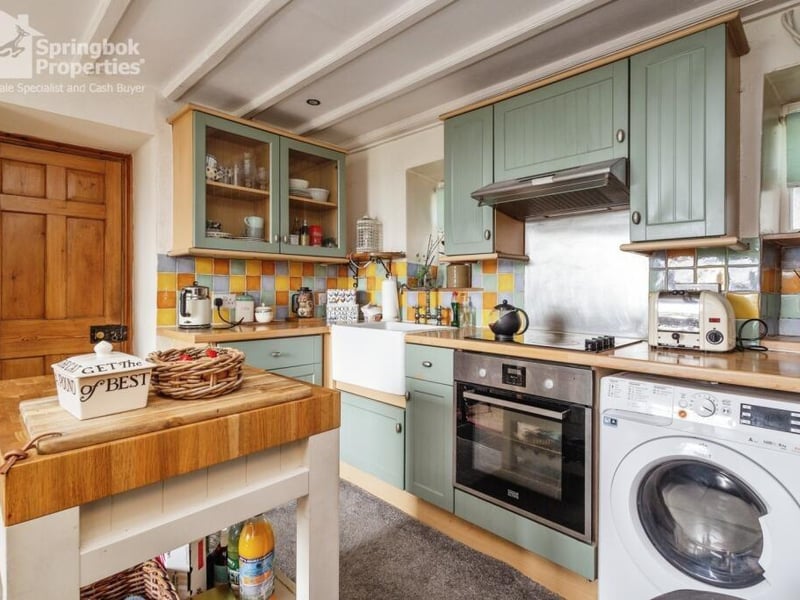A country kitchen and diner has fitted units, and doors out to a decked balcony with lovely views.