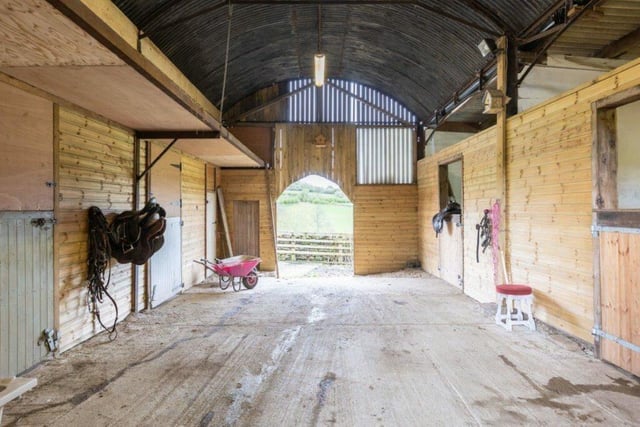 Stables are among a number of buildings that form part of the property.