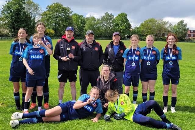 Scarborough Ladies FC Lionesses U15s players and coaches line up after their York RI Tournament win.