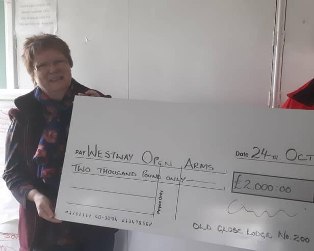 Bernie Brown from Westway Open Arms receives the cheque for £2,000 from David Birkinshaw
