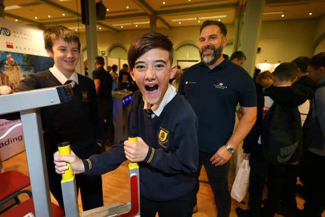 Testing strength on the Plaxton stand - St Augustines pupils with Plaxtons representative Dave Axon