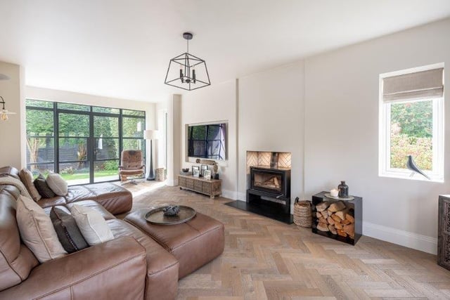 This living room with wood burning stove has Crittall style doors to outside.