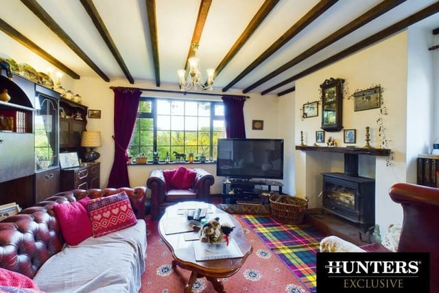 The lounge has a feature fireplace holding a cosy wood burning stove.